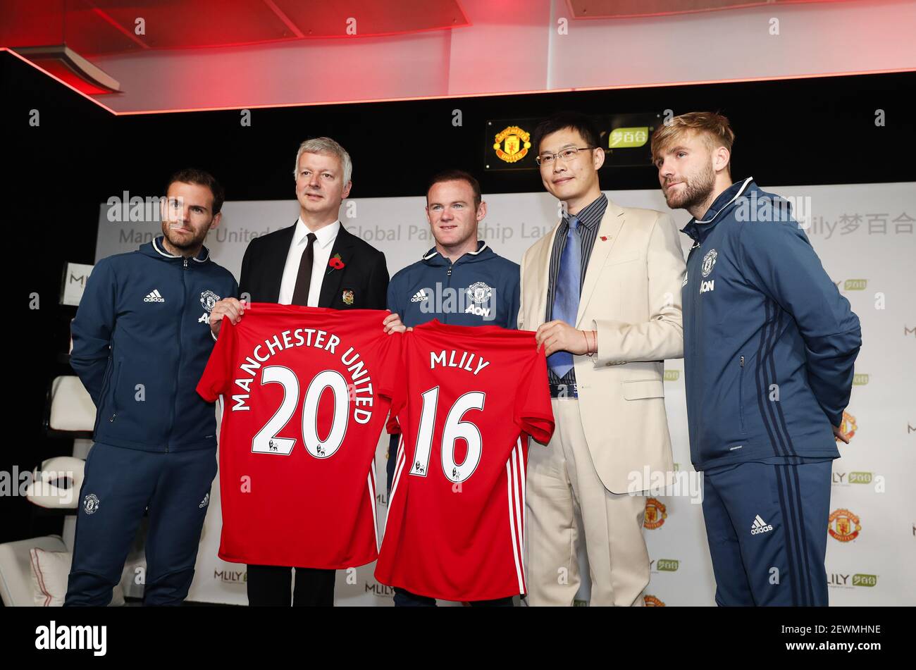 Philip Townsend (2nd L), Director of Communications for Manchester United, James Ni (2nd R), founder of Mlily and Manchester United players Juan Mata (left), Wayne Rooney (centre) and Luke Shaw (right) attend the Press Conference during which Manchester United announced a global partnership with Mlily to herald the English Premier League giant's first ever official mattress and pillow partner at its Carrington Training Complex in Manchester, England on Oct. 31, 2016. Stock Photo