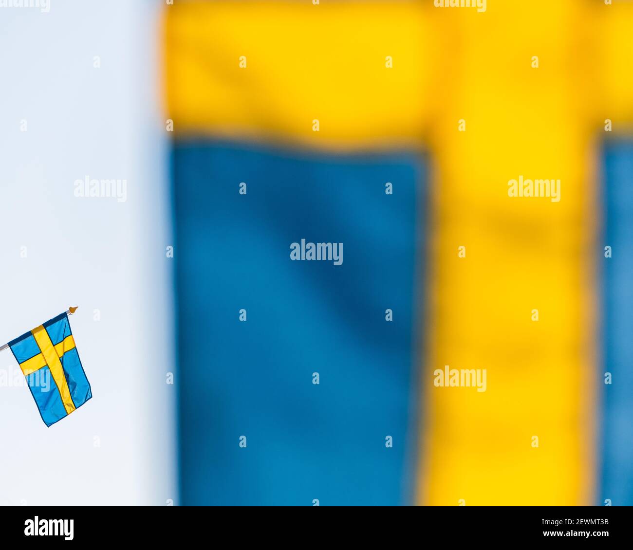 Swedish flag behind another flag Stock Photo