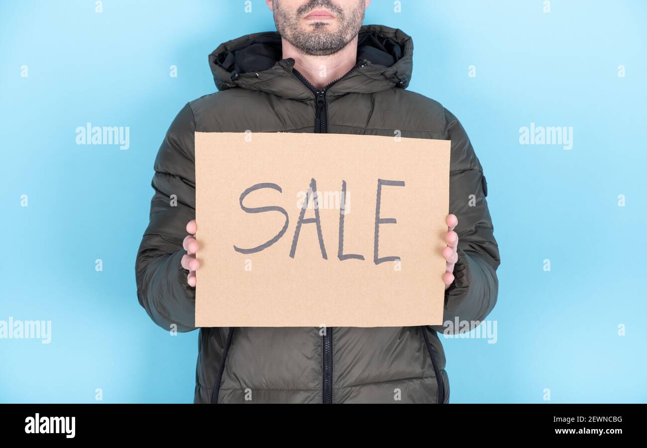 Anonymous person with a protest sign that reads 'sale' Stock Photo