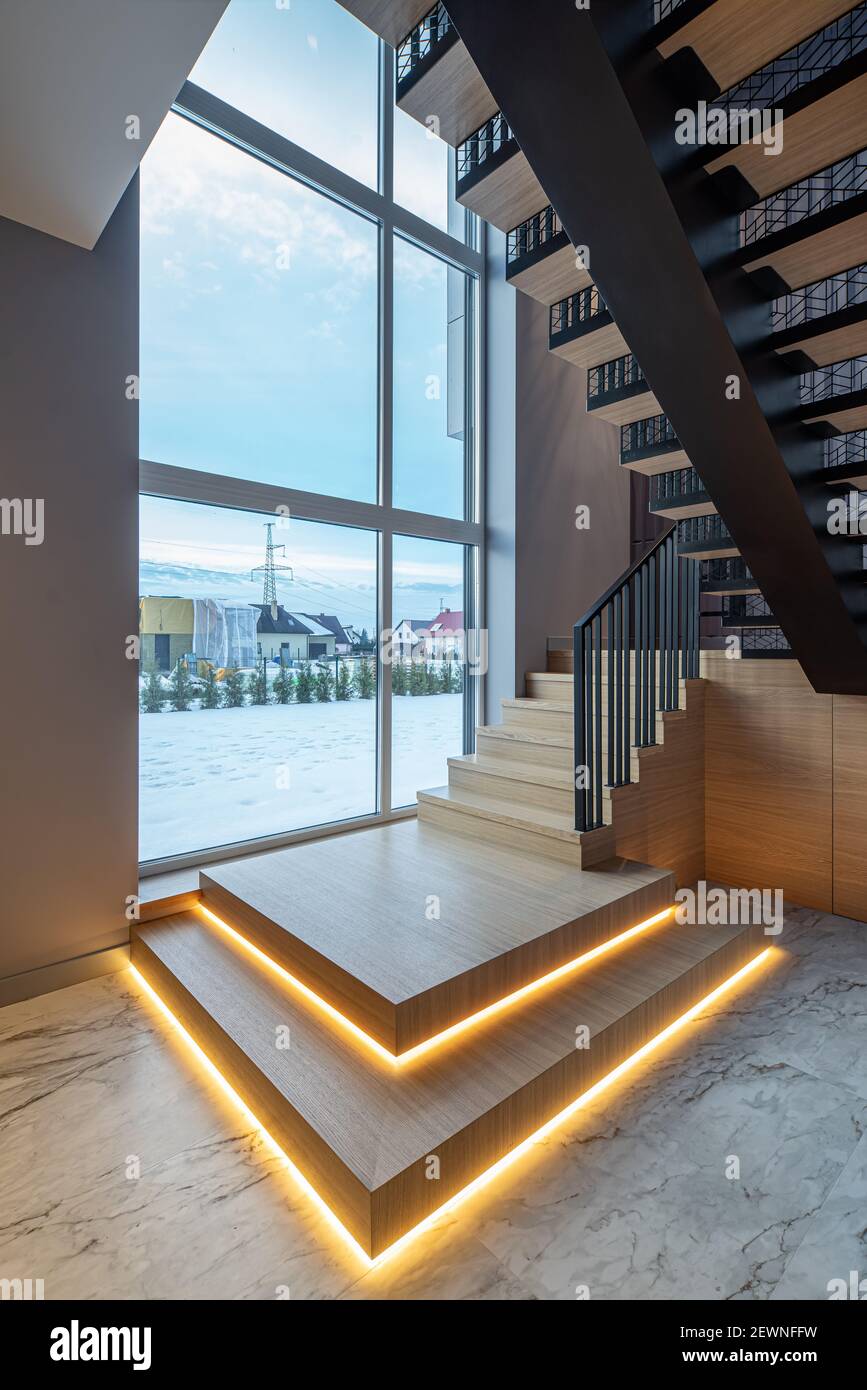 Modern interior of luxury private house. Wooden staircase with ...
