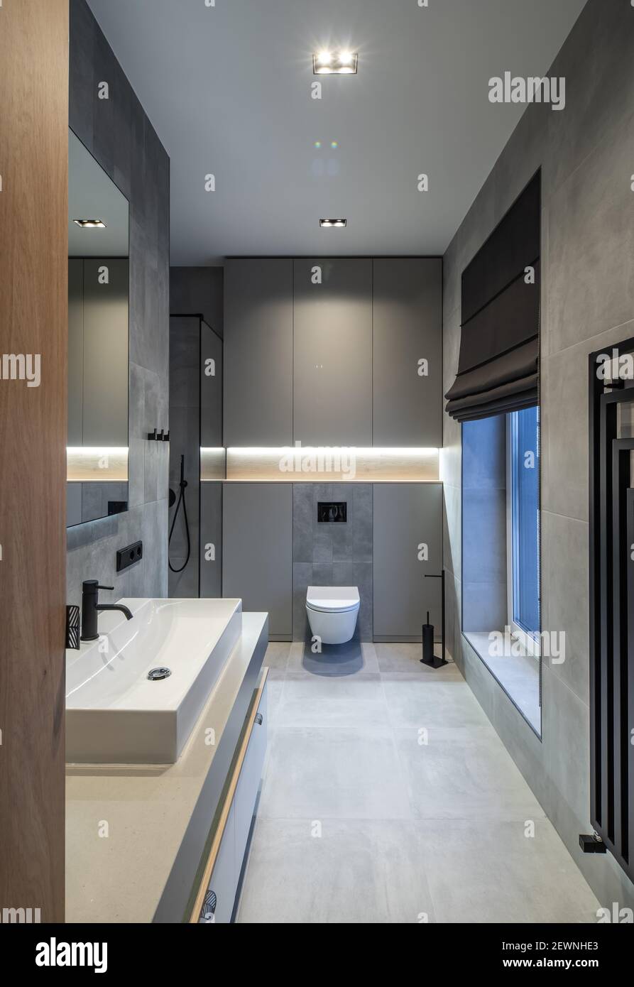 Modern interior of bathroom in luxury contemporary apartment. Grey