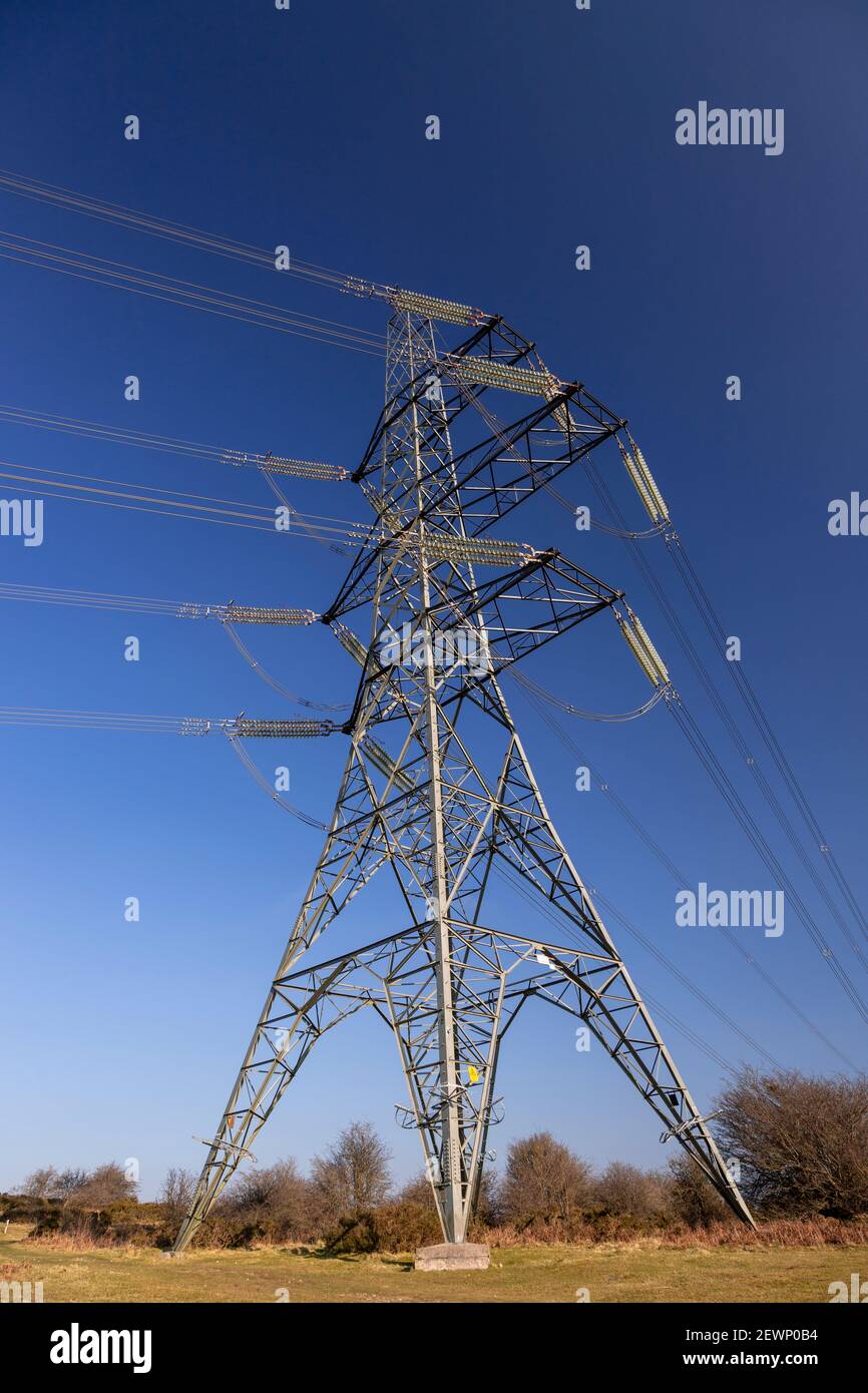 Electricity pylon and cables against a blue sky Stock Photo