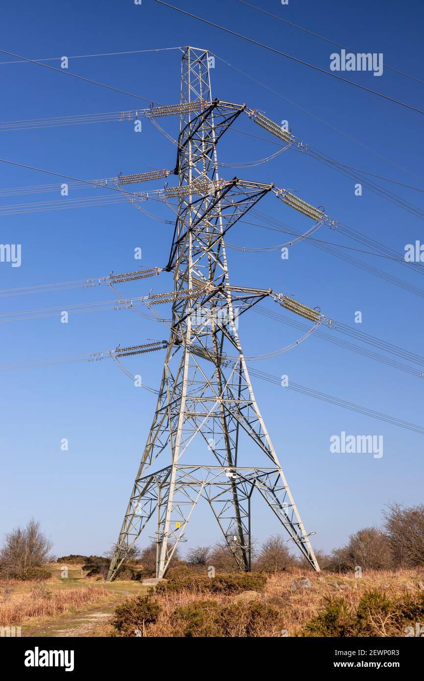 Electricity pylon and cables against a blue sky Stock Photo