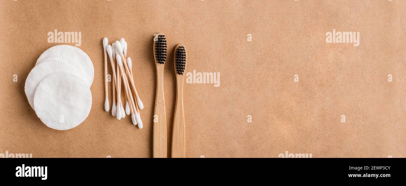 Eco friendly medical cleaning and healthcare accessories. Cotton pads, bamboo ear sticks and charcoal toothbrushes. Banner background Stock Photo
