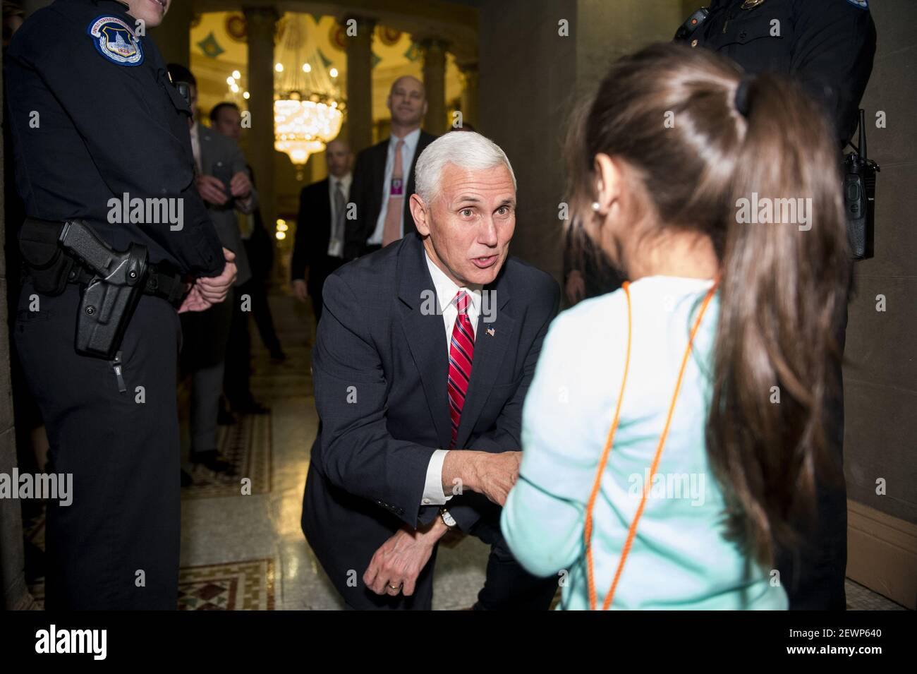 UNITED STATES - DECEMBER 6: Vice President-elect Mike Pence stops to talk with 4 year old tourist Victoria Cruz, of Orlando, Fla., as he leaves the Senate Republicans weekly policy lunch in the Capitol on Tuesday, Dec. 6, 2016. Victoria and her mother Elena were in the Rotunda on a tour of the Capitol when the Vice President-elect stopped to greet them. (Photo By Bill Clark/CQ Roll Call) *** Please Use Credit from Credit Field *** Stock Photo