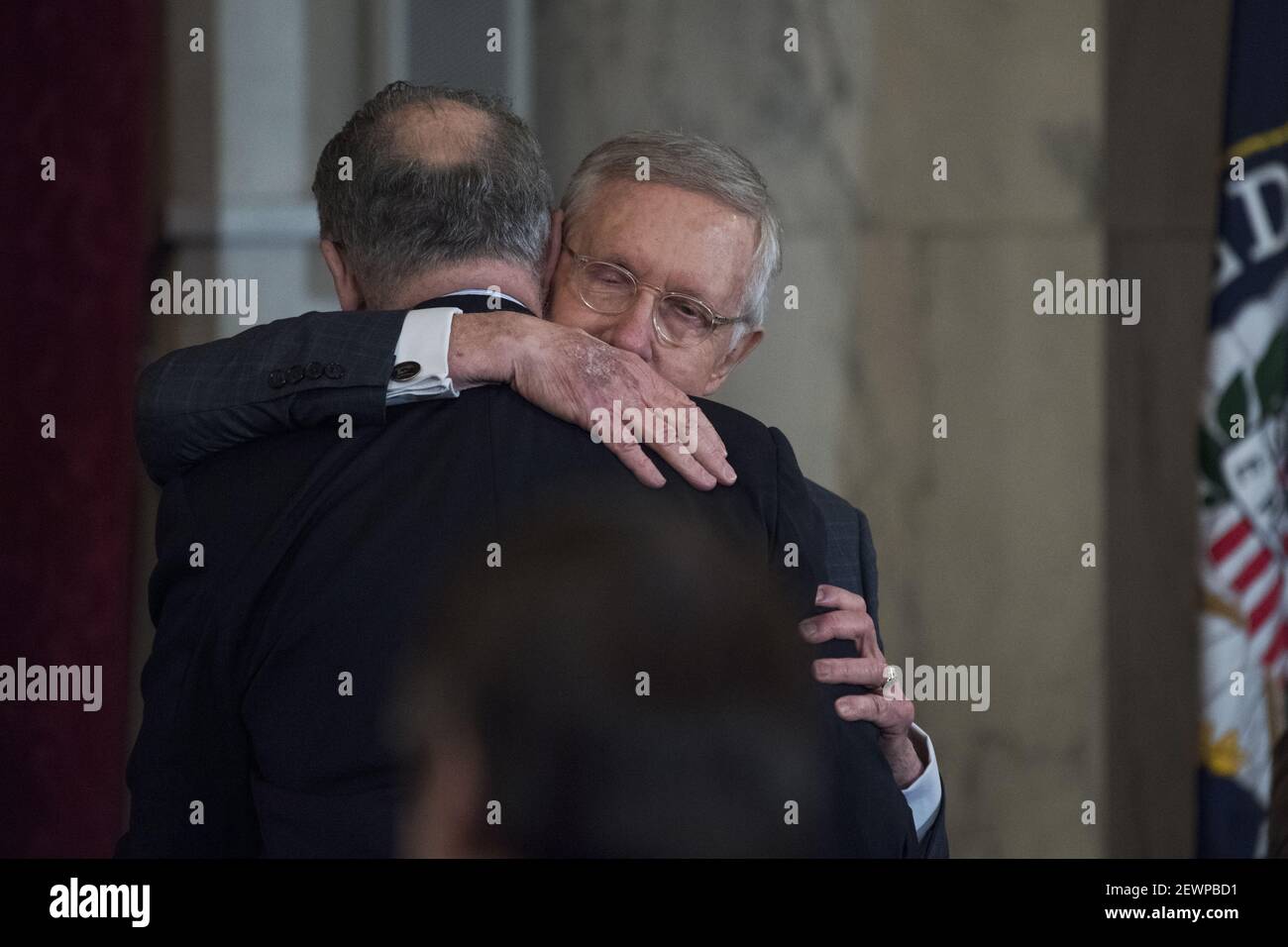 UNITED STATES - DECEMBER 08: Retiring Senate Minority Leader Harry Reid, D-Nev., right, hugs incoming Senate Minority Leader Charles Schumer, D-N.Y., during Reid's portrait unveiling ceremony in Russell Building's Kennedy Caucus Room, December 08, 2016. (Photo By Tom Williams/CQ Roll Call) *** Please Use Credit from Credit Field *** Stock Photo