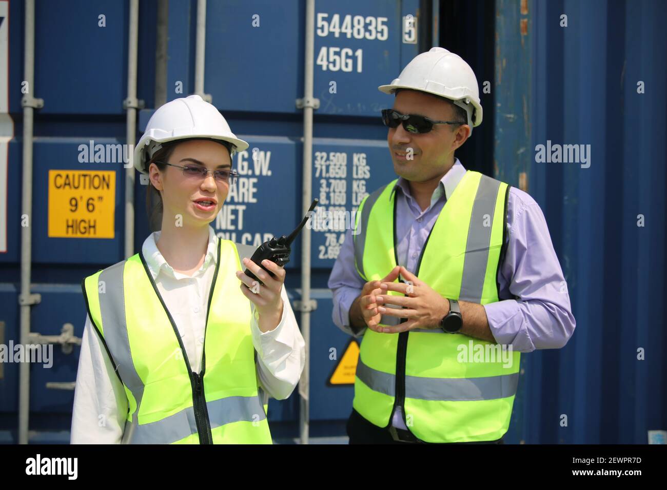 Logistics engineer control at the port, loading containers for trucks ...