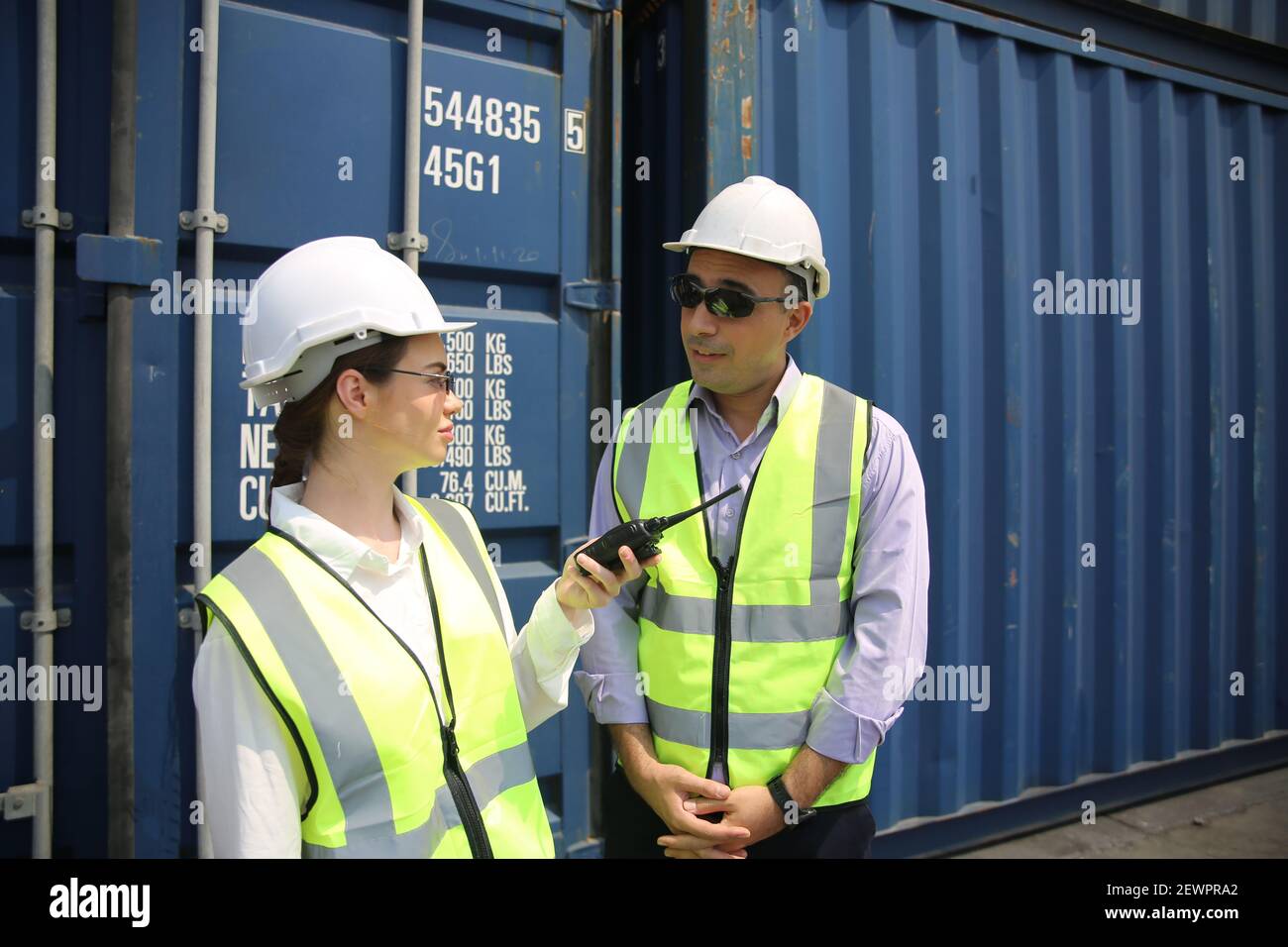 Logistics engineer control at the port, loading containers for trucks ...