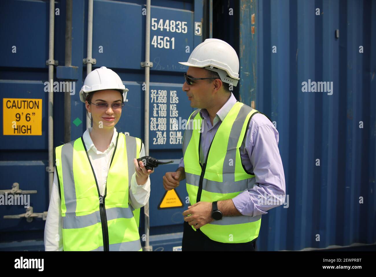 Logistics engineer control at the port, loading containers for trucks ...
