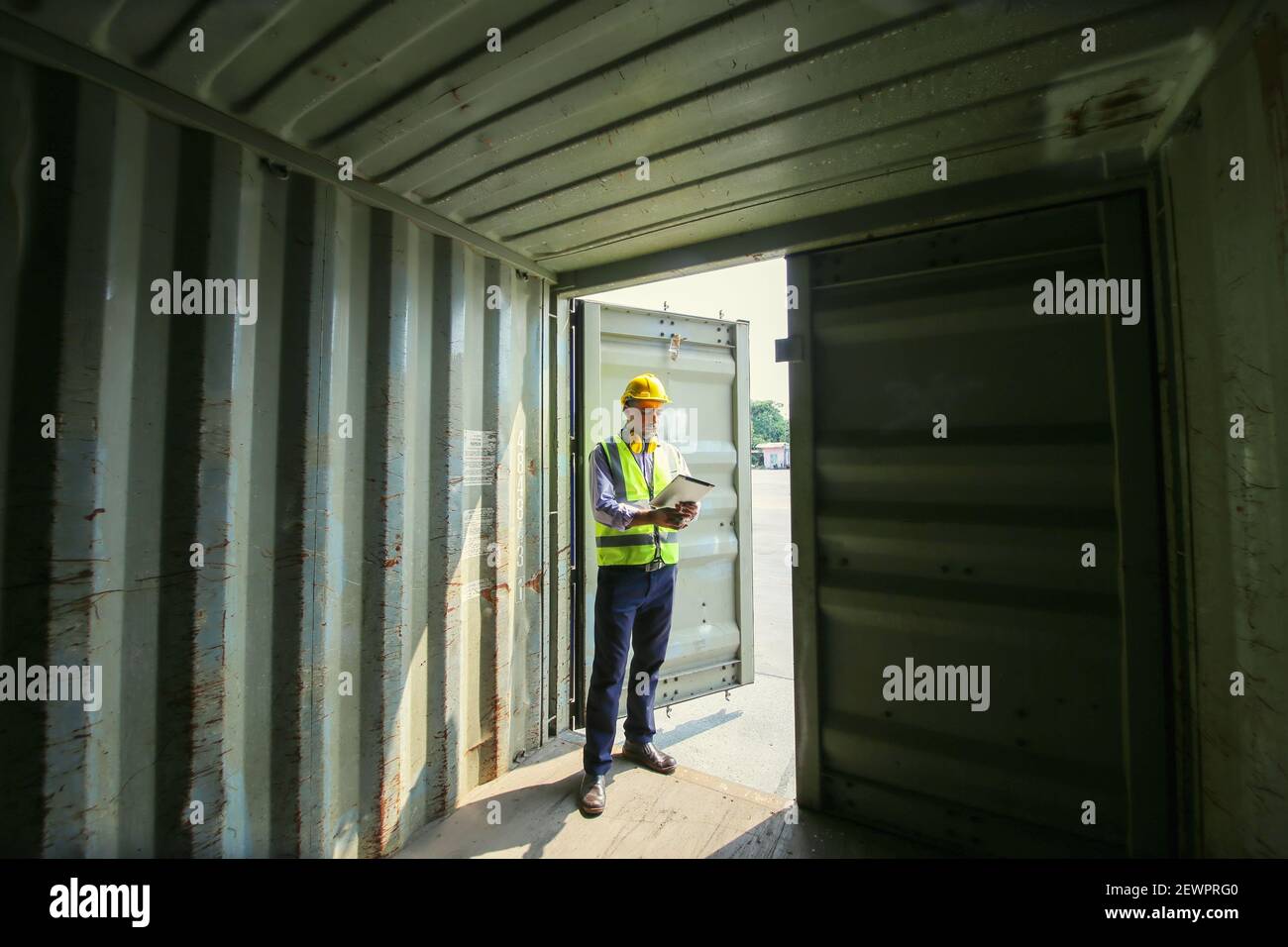 Logistics engineer control at the port, loading containers for trucks ...