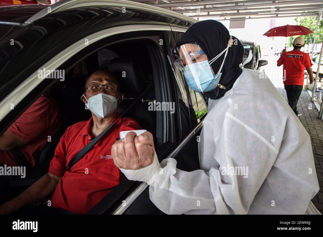 Jakarta, Indonesia. 3rd Mar, 2021. A man has his body condition checked before receiving the COVID-19 vaccine during a drive-thru vaccination campaign for elderly people in Jakarta, Indonesia, March 3, 2021. Credit: Agung Kuncahya B./Xinhua/Alamy Live News Stock Photo