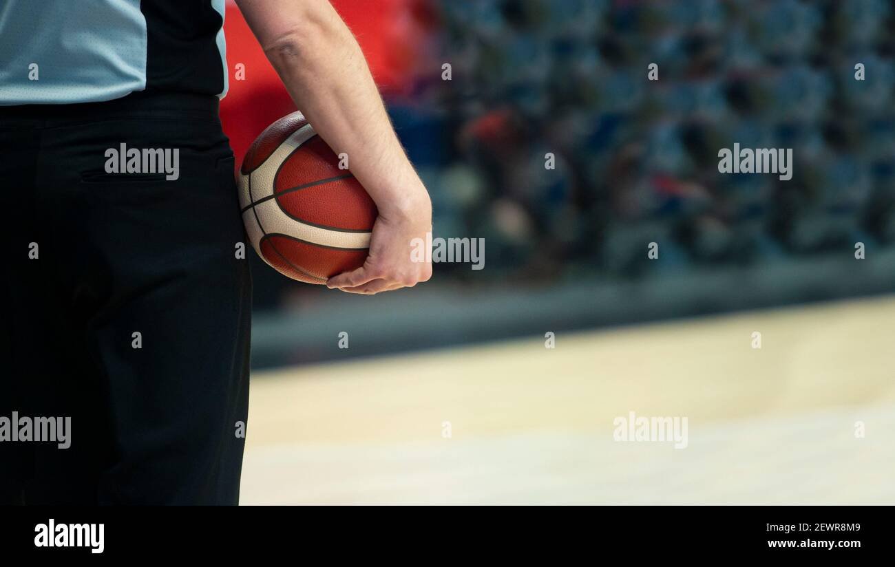 Basketball referee with ball on sport hall background Stock Photo Alamy