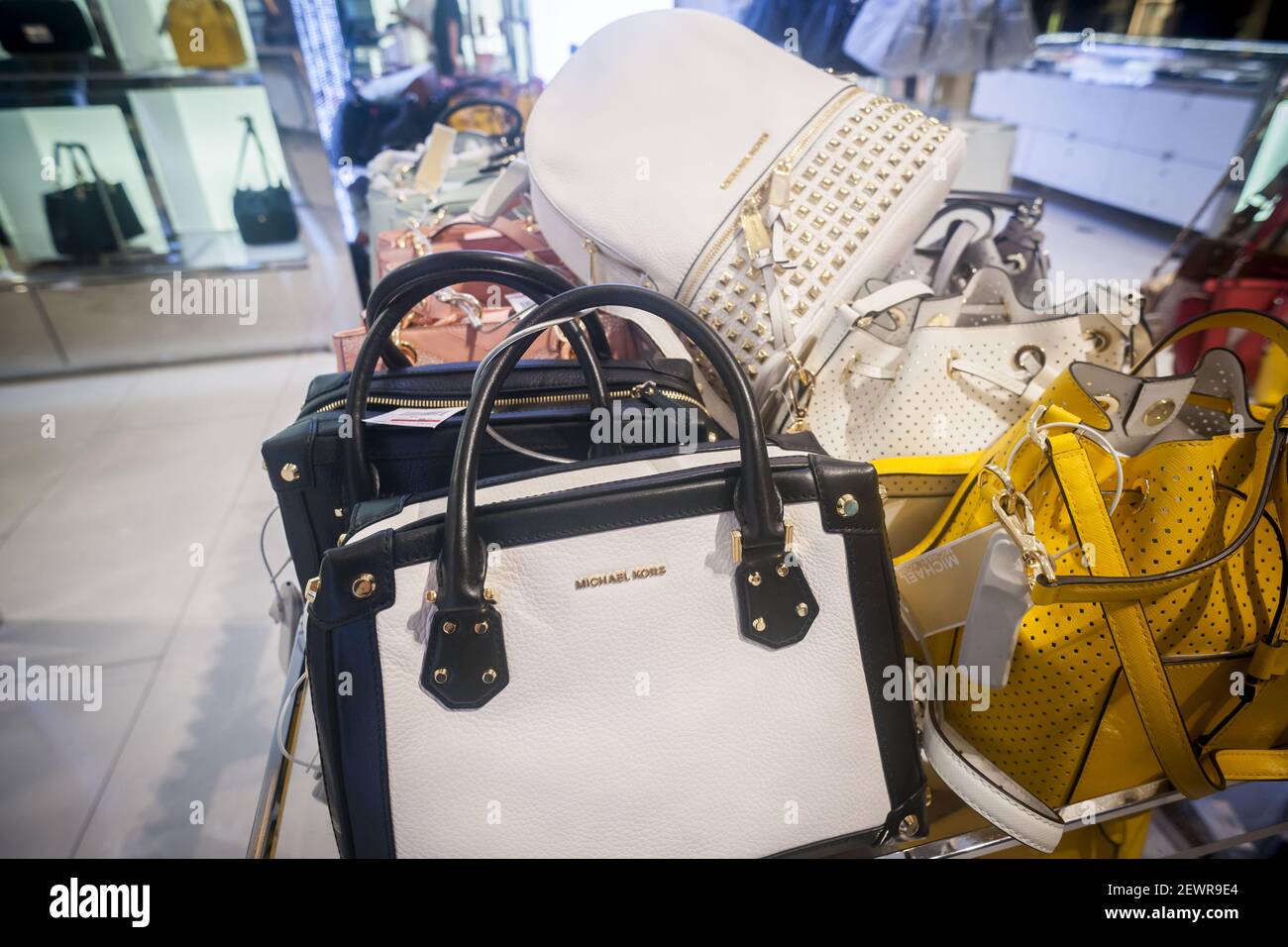 Handbags and accessories on display at the Michael Kors boutique within  Macy's in New York on Tuesday, May 31, 2016. Michael Kors is scheduled to  report fiscal third-quarter earnings and revenue prior