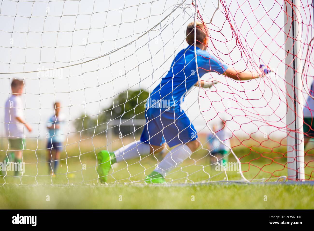 Football Goalkeeper Running and Catching Ball in a Goal. View from