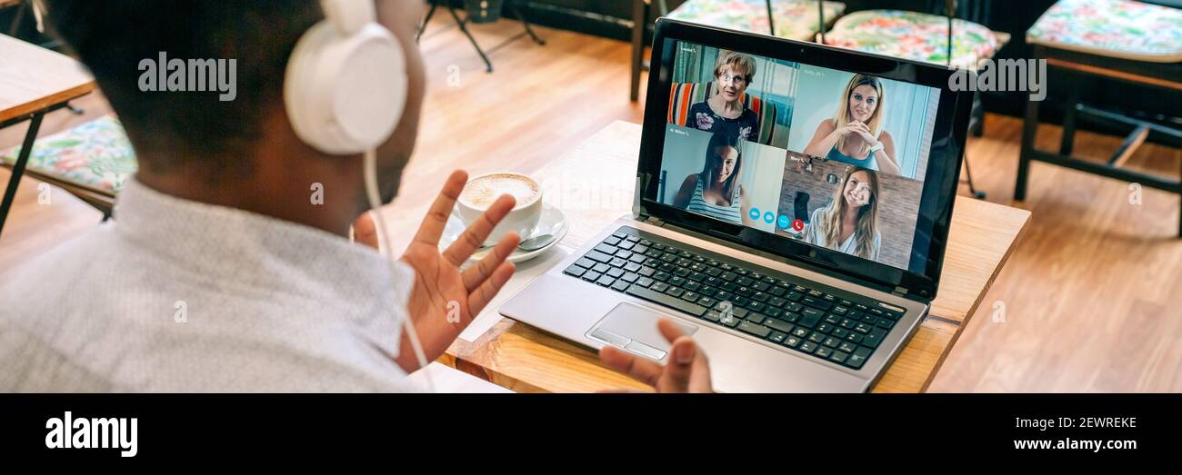 Man talking on video call with friends from a cafeteria Stock Photo