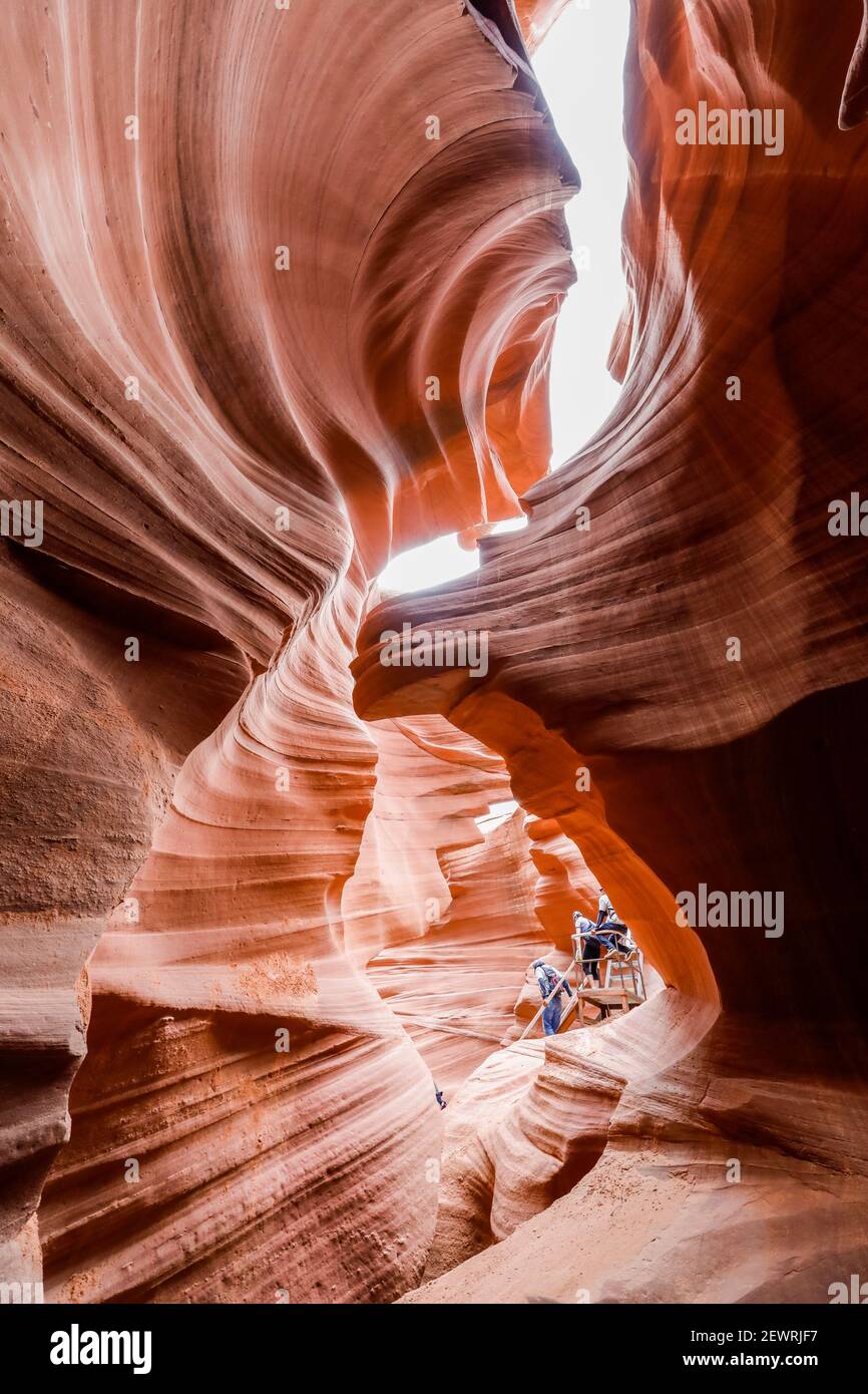 Tourists explore a slot canyon in Upper Antelope Canyon, Navajo Land, Arizona, United States of America, North America Stock Photo