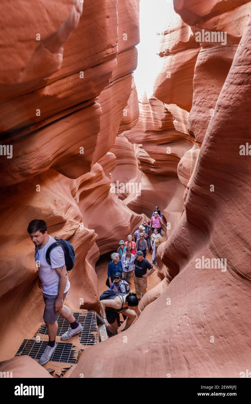 Tourists explore a slot canyon in Upper Antelope Canyon, Navajo Land, Arizona, United States of America, North America Stock Photo