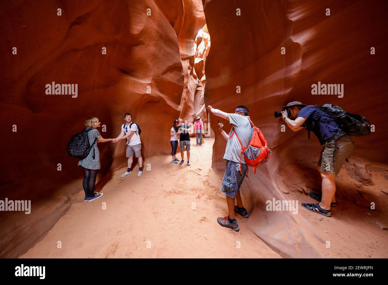 Tourists explore a slot canyon in Upper Antelope Canyon, Navajo Land, Arizona, United States of America, North America Stock Photo