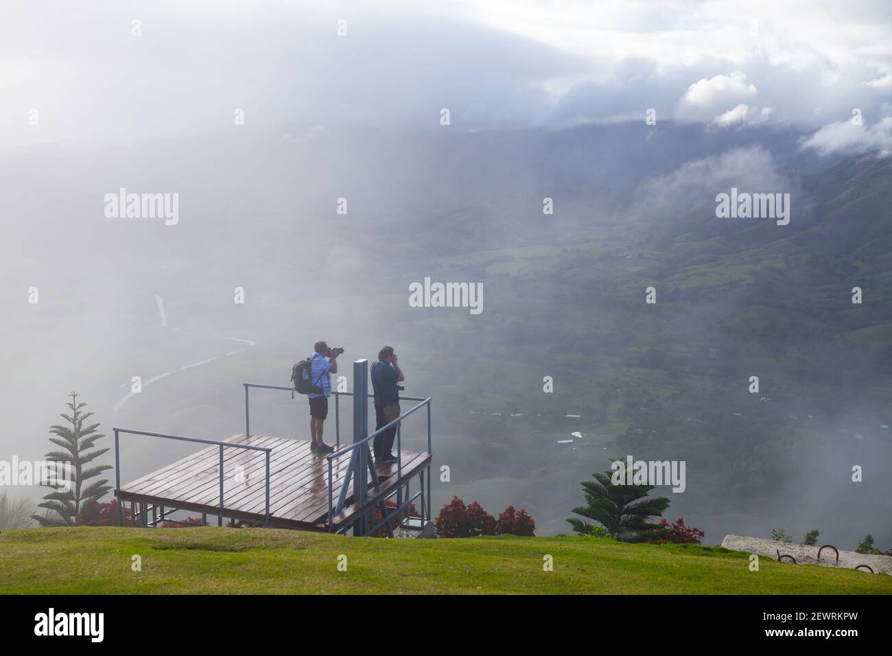 Montana Redonda, Dominican republic - January 7, 2020: Tourists taking photo with Mountain landscape on a rainy sunny morning from viewpoint of Montan Stock Photo