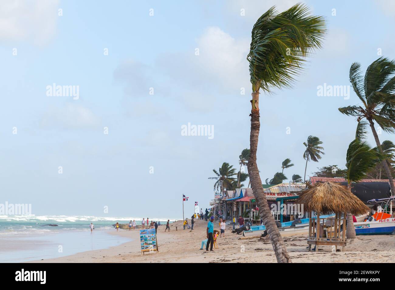 Punta Cana, Dominican republic - January 14, 2020: Tourists are on the beach of Punta Cana resort near small souvenir shops and restaurants Stock Photo