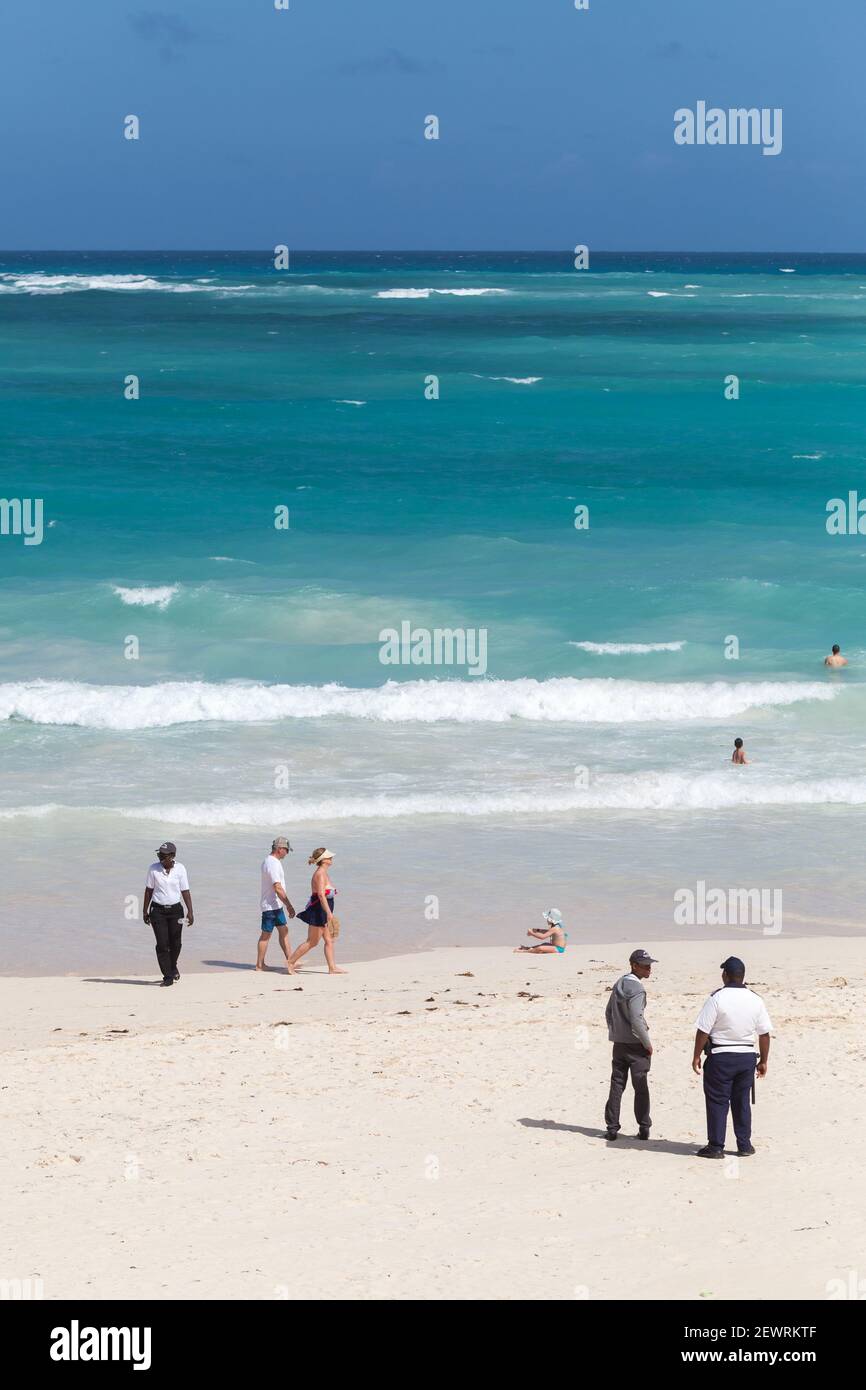 Punta Cana, Dominican republic - January 15, 2020: Tourists and hotel staff are on a sandy beach of Punta Cana resort town on a sunny day Stock Photo