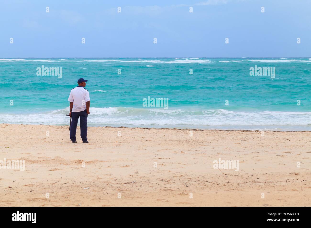 Punta Cana, Dominican republic - January 10, 2020: Security guard stands on a sandy beach of Punta Cana resort town Stock Photo