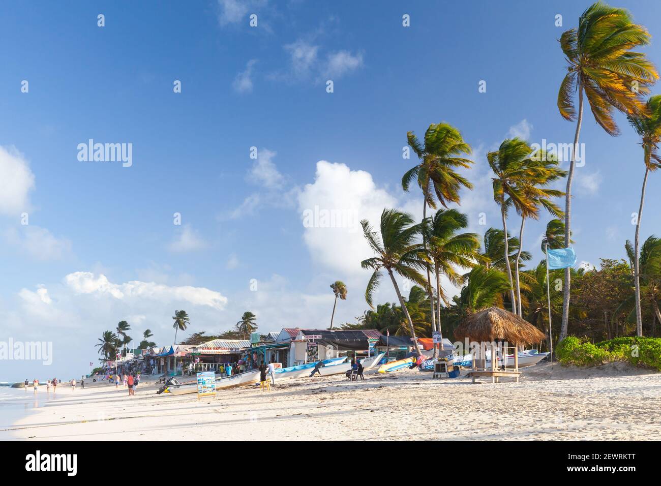 Punta Cana, Dominican republic - January 15, 2020: Tourists and staff are on a sandy beach of Punta Cana resort near small souvenir shops and beach re Stock Photo