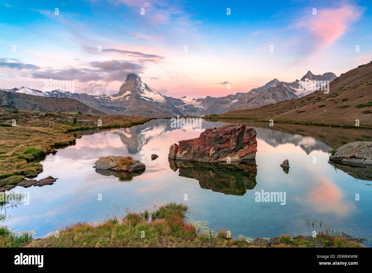 Pink sky at dawn over Matterhorn reflected in lake Stellisee, Zermatt, Valais Canton, Switzerland, Europe Stock Photo