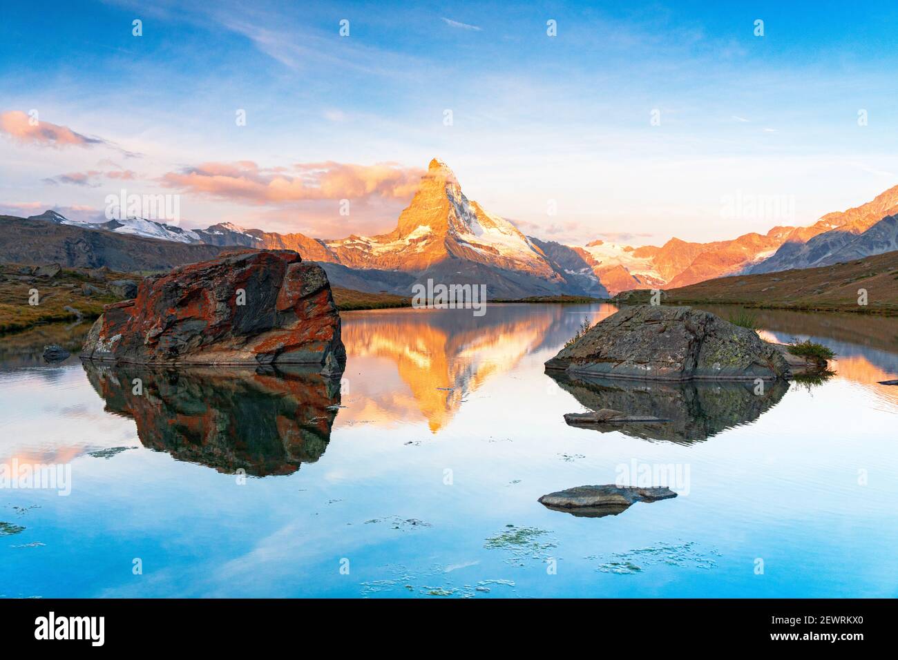 Matterhorn lit by sunrise reflected in the calm water of lake Stellisee, Zermatt, Valais Canton, Switzerland, Europe Stock Photo