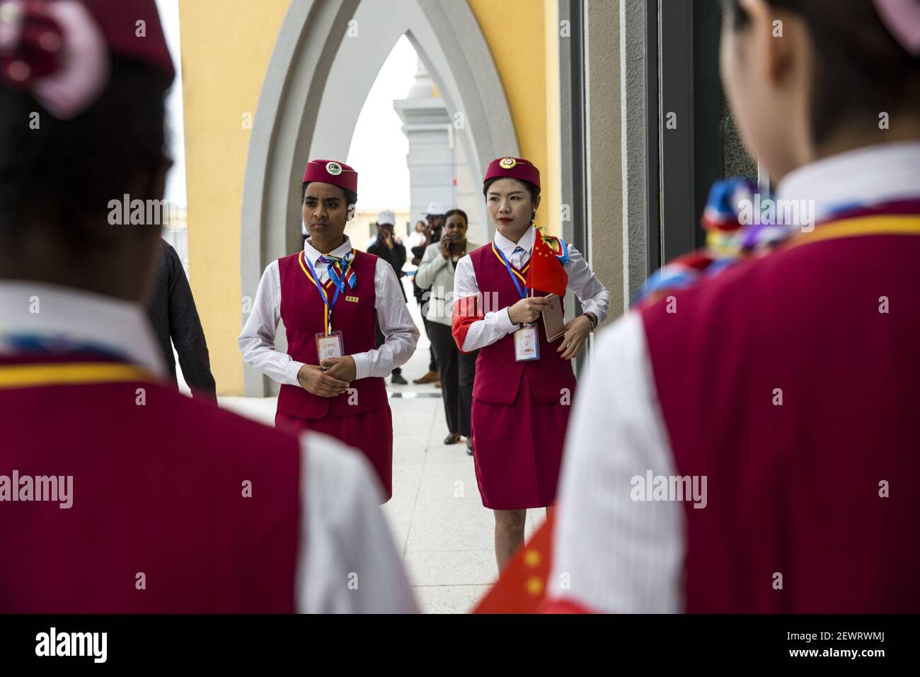 --FILE--African and Chinese railway attendants wearing standard ...