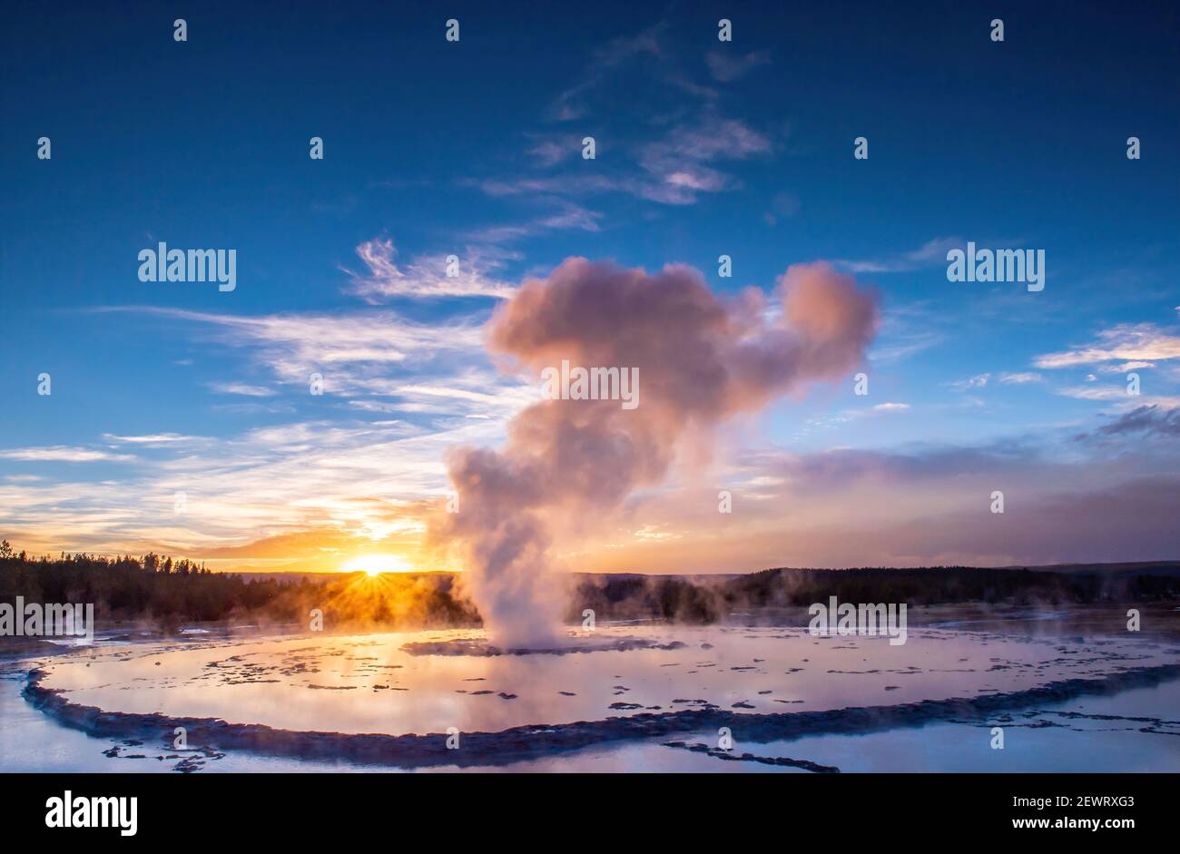 Great Fountain Geyser at sunset with reflection and sunburst, Yellowstone National Park, UNESCO World Heritage Site, Wyoming, United States of America Stock Photo