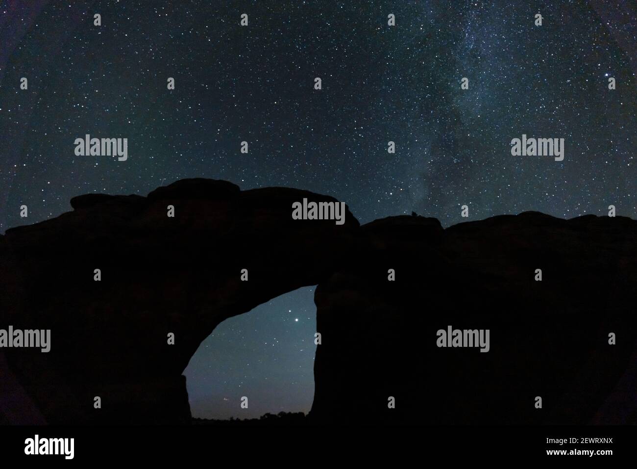 Starry sky viewed through Broken Arch, Arches National Park, Utah, United States of America, North America Stock Photo
