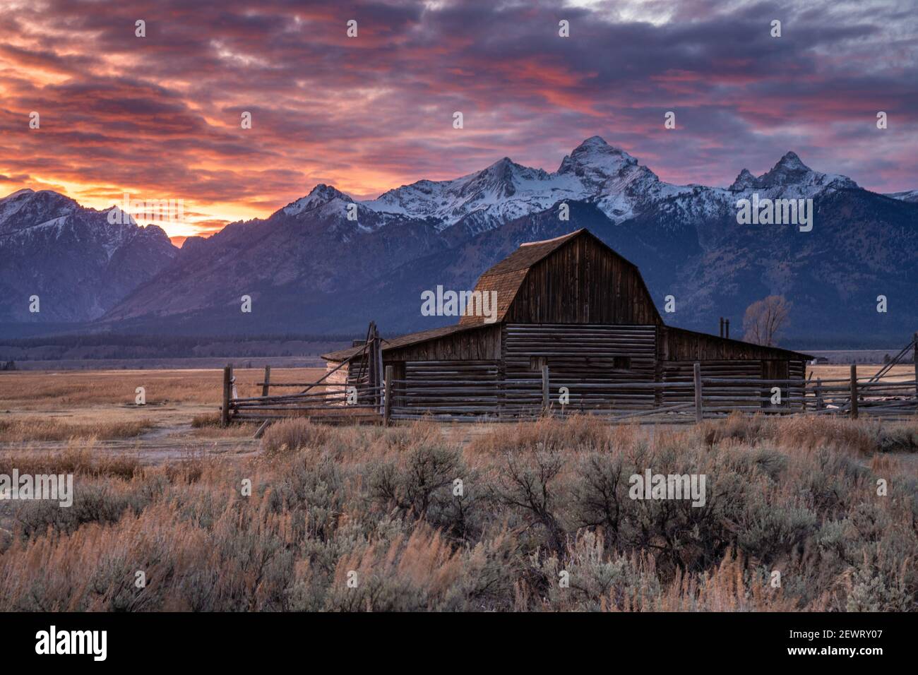 Sun setting over the Teton Range at Moulton Barn, Grand Teton National Park, Wyoming, United States of America, North America Stock Photo