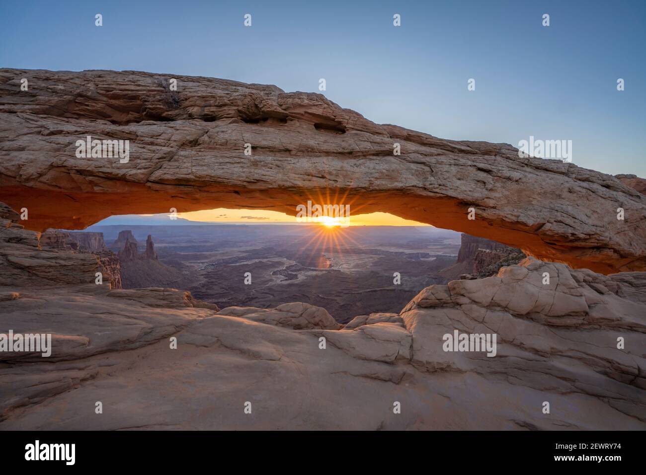 Sunrise at Mesa Arch with glowing arch and sunburst, Canyonlands National Park, Utah, United States of America, North America Stock Photo