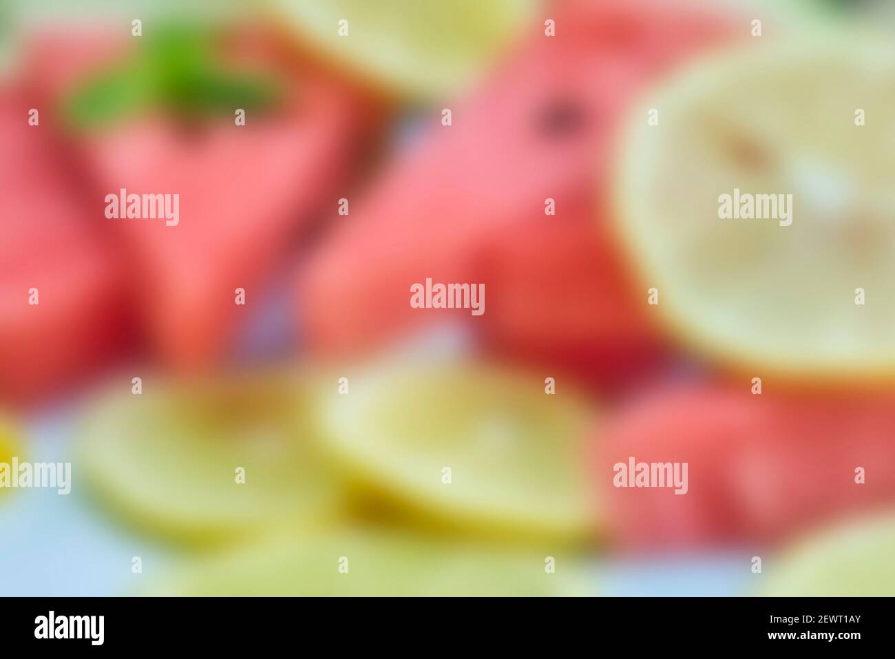 Blurred shot of fresh summer fruits background. Sweet watermelon and lemon slices. Watermelon fruit. Summer fruits background with gaussian blur Stock Photo