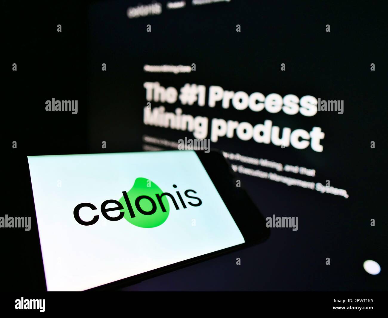 Mobile phone with business logo of German software development company Celonis SE on screen in front of web page. Focus on center of phone display. Stock Photo