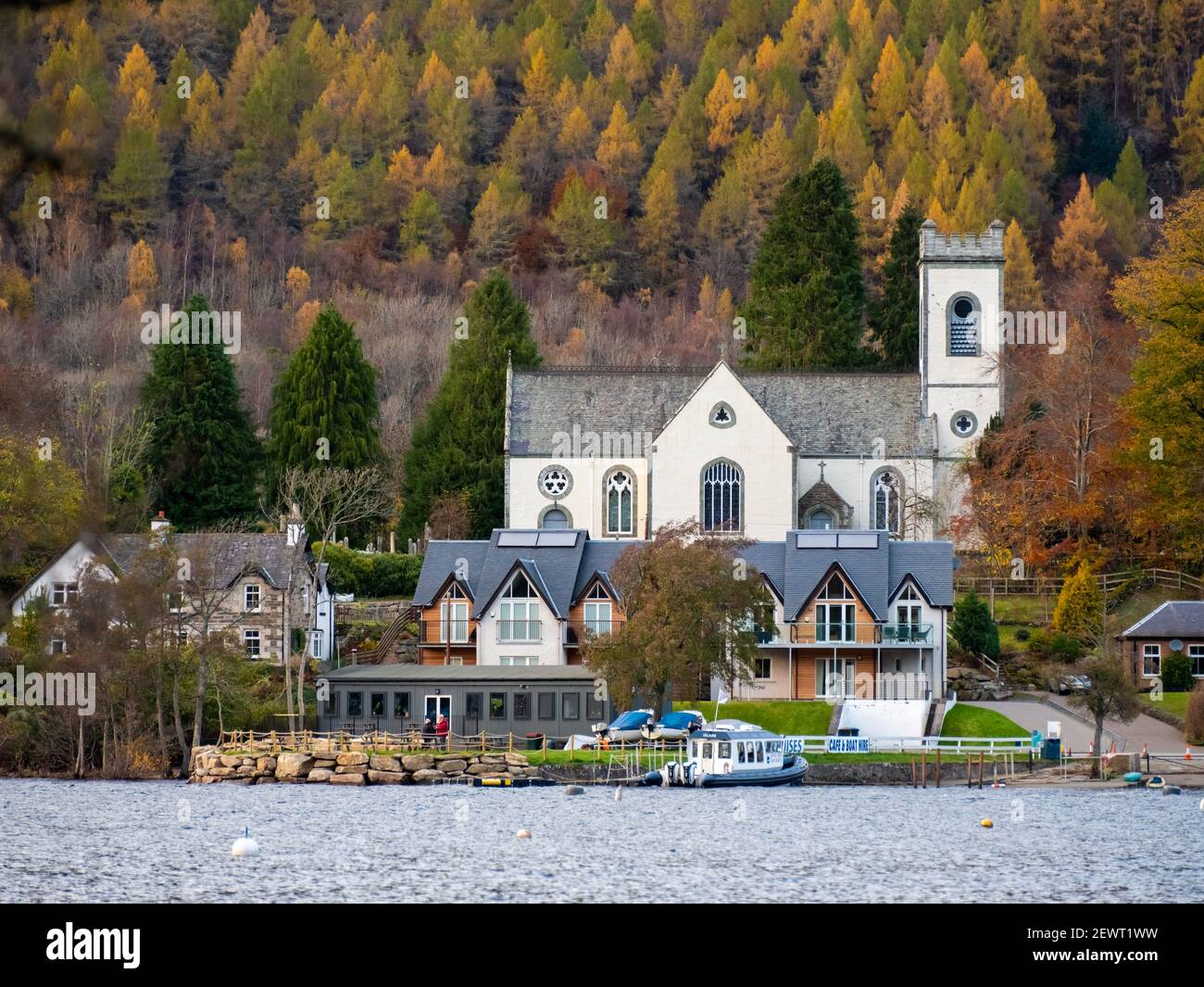 View across Loch Tay towards the village of Kenmore in autumn and Kenmore church, Kenmore, Perthshire, Scotland, UK Stock Photo