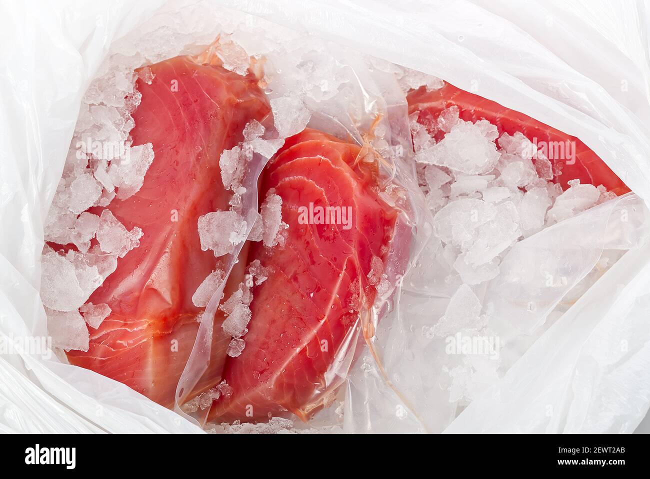 Frozen Tuna steak vacuum with ice in plastick bag, fresh food delivery