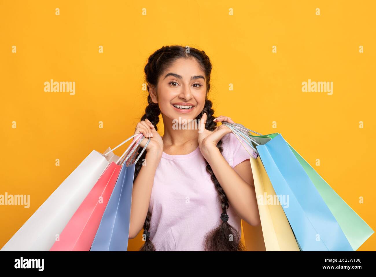 Indian woman holding colorful shopping bags at studio Stock Photo - Alamy