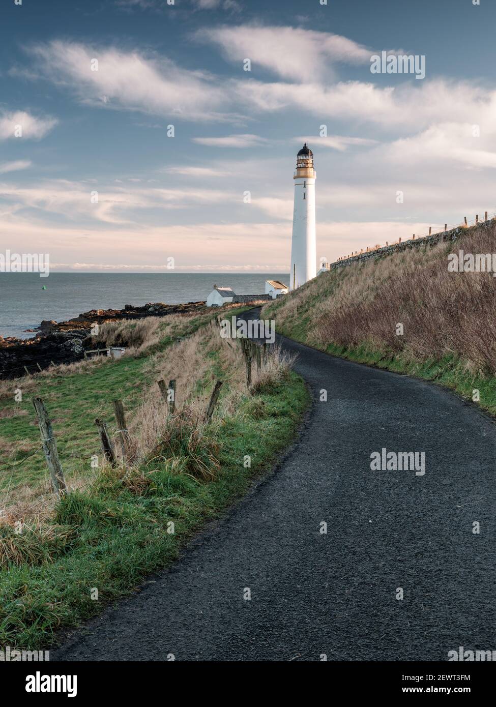 View of Scurdie Ness Lighthouse looking down the lane leading from the town of Montrose, Angus, Scotland Stock Photo