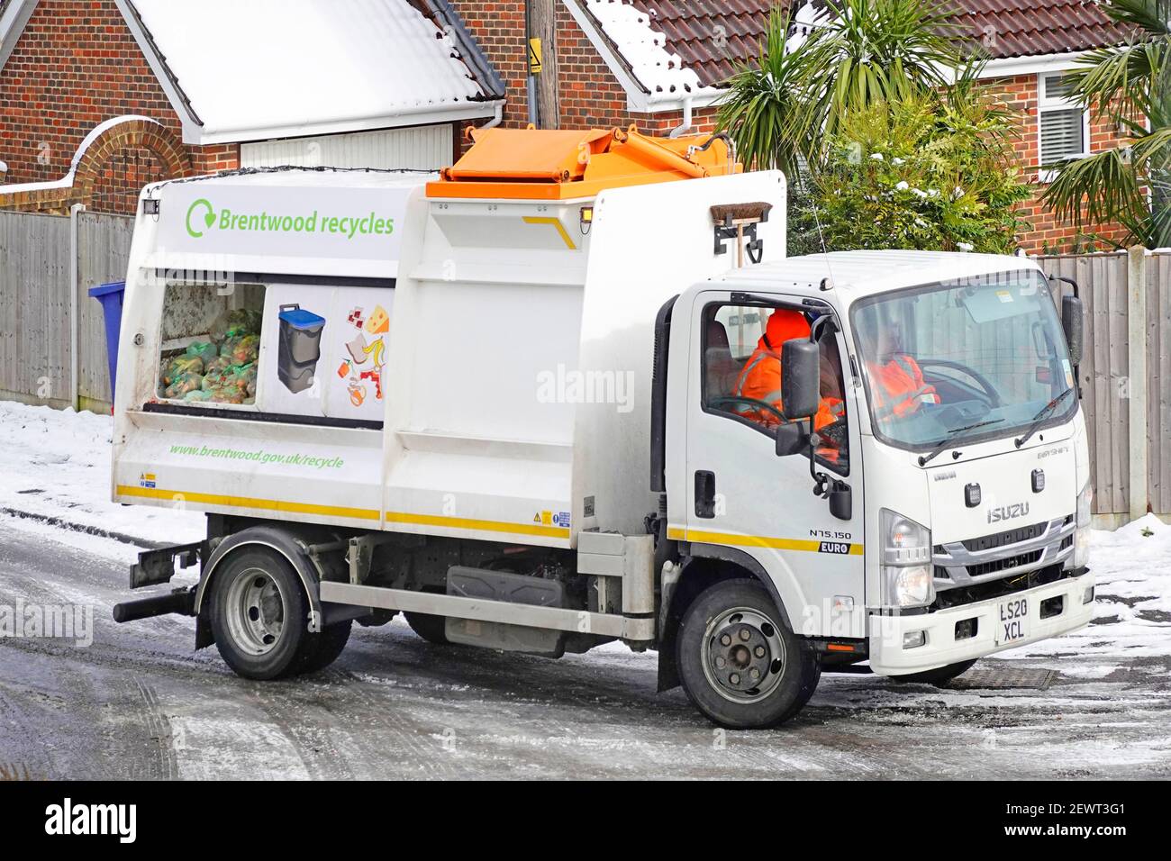 Brentwood Council recycling food waste management & collecting dustcart  lorry truck work in cold ice & snow recycle wheelie bin caddy bag emptying  UK Stock Photo - Alamy