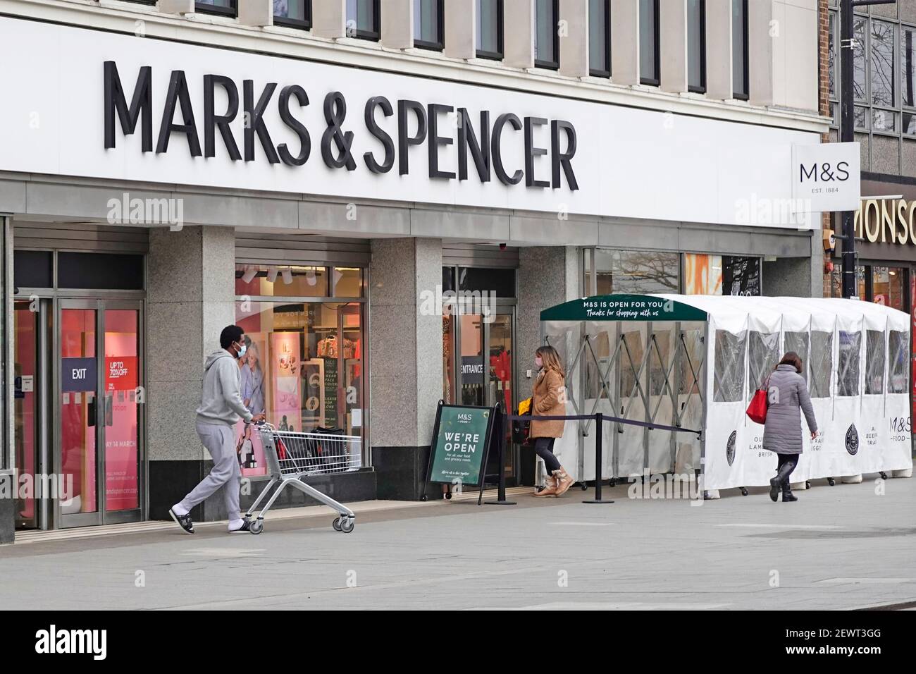 Marks and Spencer shop front & all weather food shopping shelter one way M&S entrance tunnel & separate exit coronavirus corvid 19 pandemic Essex UK Stock Photo