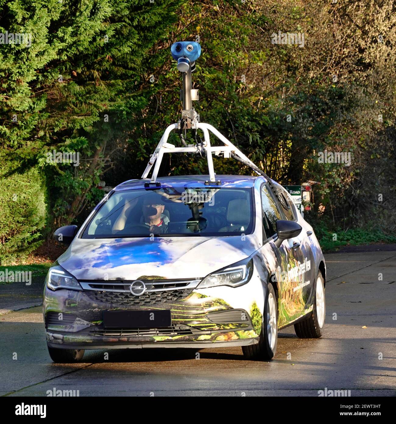 Close up front of Google car & video camera rig fixed to vehicle roof filming street view property map image driver residential road Essex England UK Stock Photo