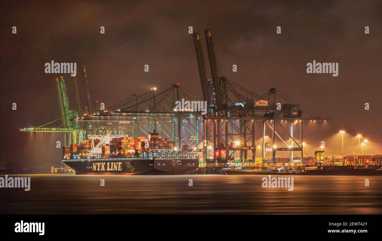 Large container terminal with moored vessels at night. The Port of ...