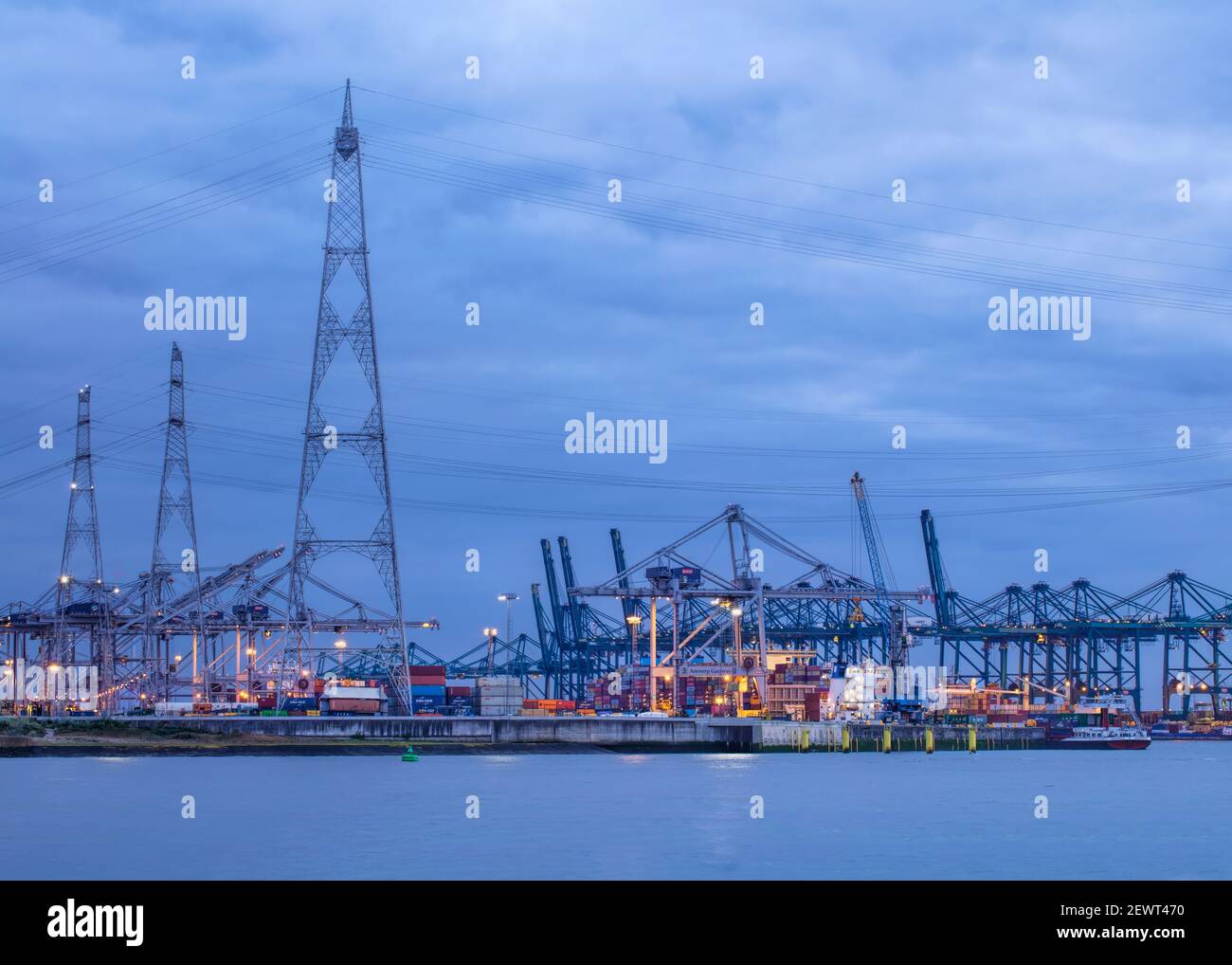 Illuminated container terminal at twilight. The Port of Antwerp in ...