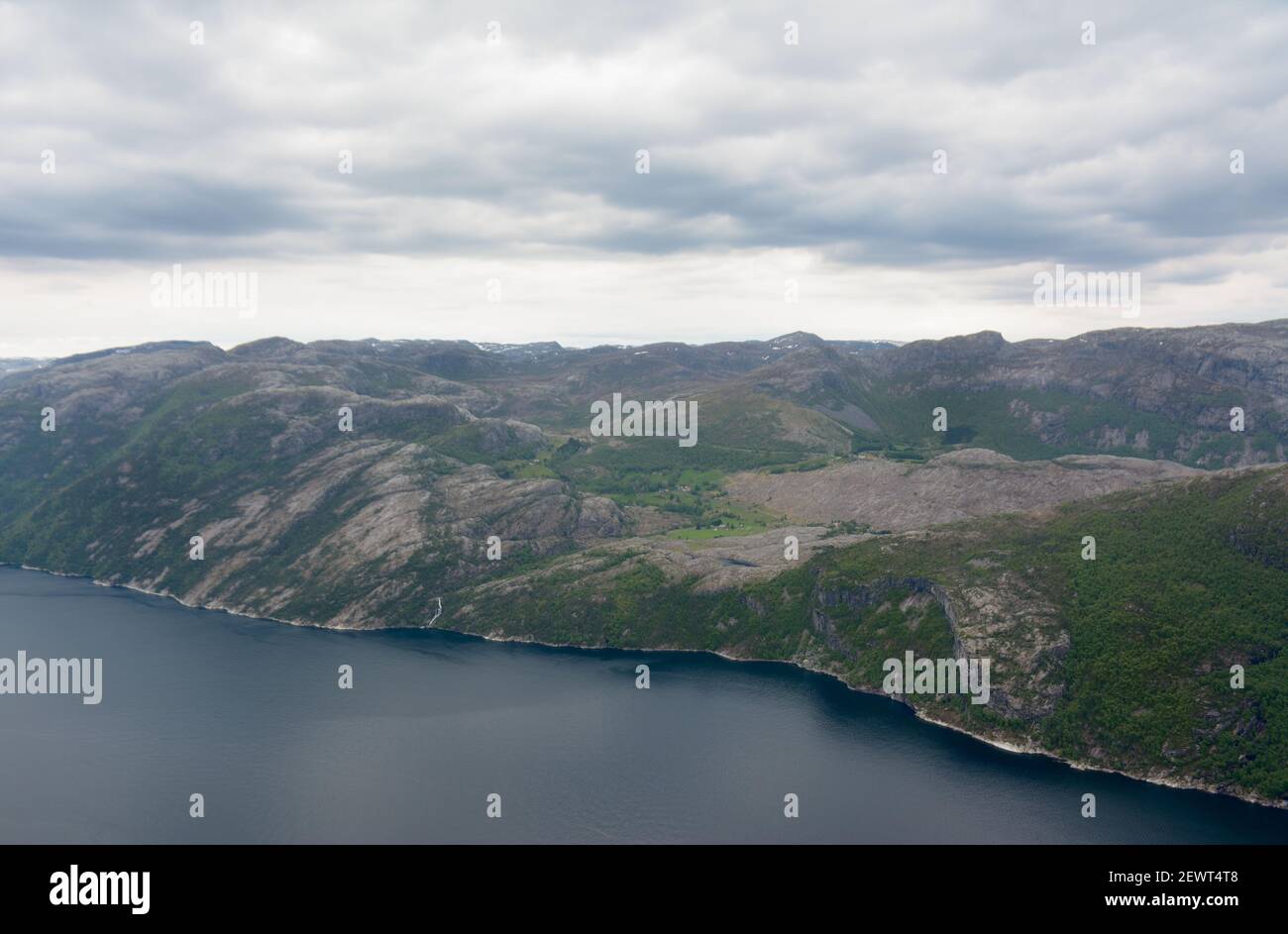 View of a landmass across the Lysefjorden on a dull overcast day from Preikestolen in Stavanger, Norway. Stock Photo