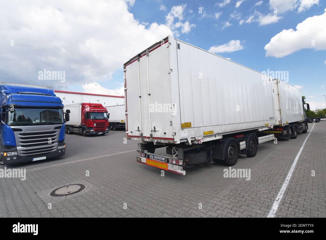 Trucks loading at a depot of a forwarding agency - Transport and logistics in goods trade Stock Photo
