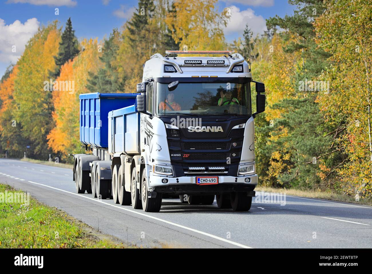 Silver Scania R650 XT truck pulls gravel trailer along Highway 10 on a beautiful day of autumn. Tammela, Finland. October 2, 2020. Stock Photo