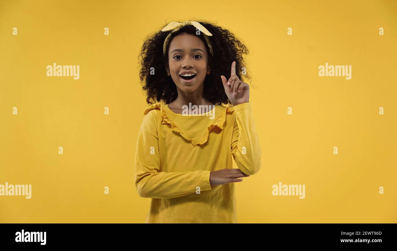 amazed african american girl having idea isolated on yellow Stock Photo