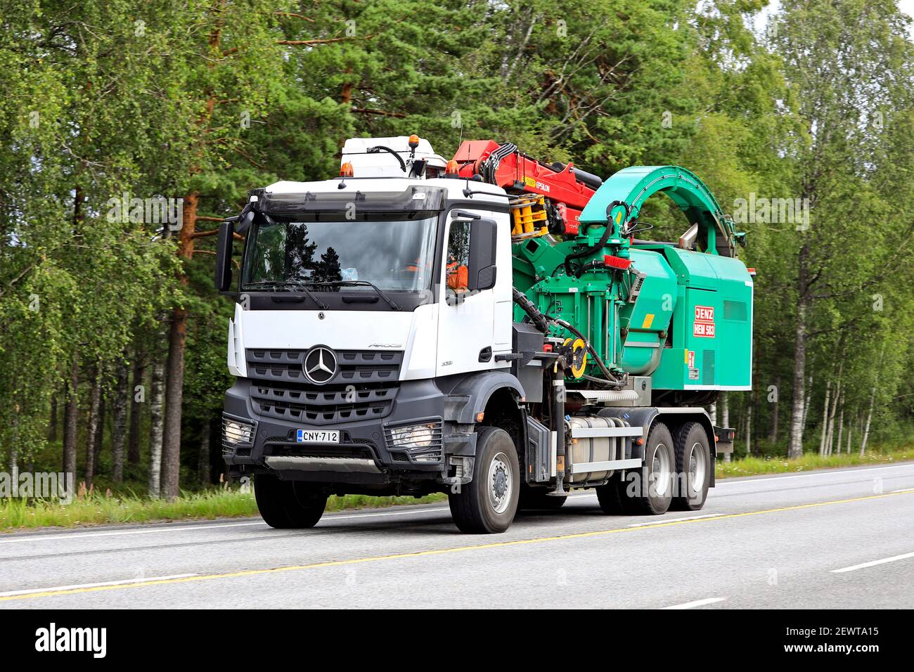 Jenz Hem 583 wood chipper mounted on Mercedes-Benz Arocs 3351 truck, on the move on Highway 25 in Raasepori, Finland. July 24, 2020. Stock Photo